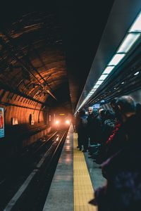 People waiting train at railroad station platform
