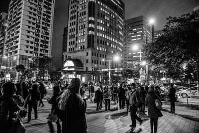 Crowd on city street at night