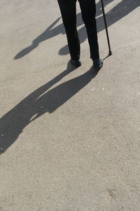 Low section of man walking on street