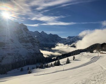 Scenic view of snow covered mountains against sky