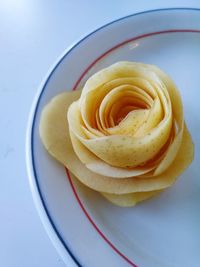 High angle view of yellow rose on table