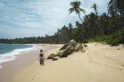 Full length of man on beach against sky