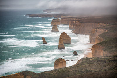 Scenic view of land by sea