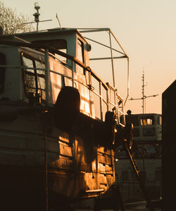 Low angle view of silhouette people against orange sky