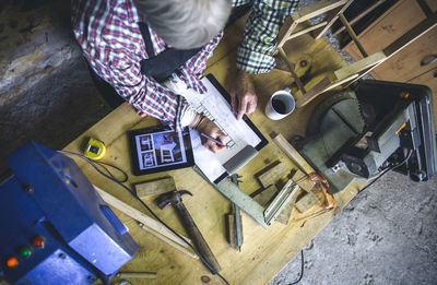 High angle view of man and woman working on table