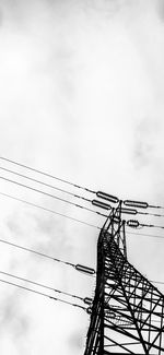 Low angle view of electricity pylon against sky