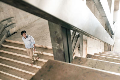 High angle view of man moving down on steps