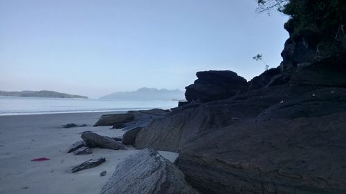 Scenic view of sea and mountains against sky