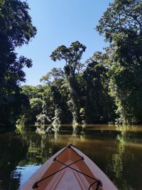 Swimming pool by lake against sky