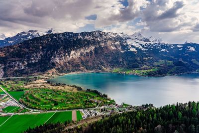 Scenic view of lake and mountains against sky