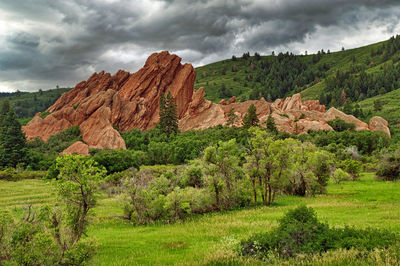 Dark storm clouds over the striking red sandstone fountain formations at roxborough state park, co.
