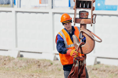 Side view of man working at construction site