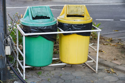 Yellow garbage bin on road