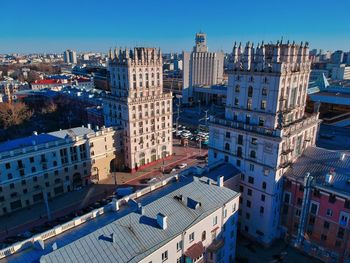 High angle view of buildings against blue sky