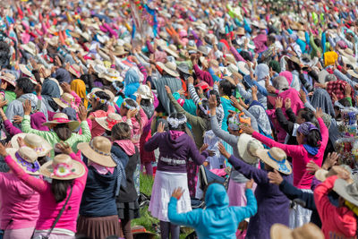 Crowd with arms raised during holy mass