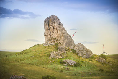 Rock formations on landscape against sky