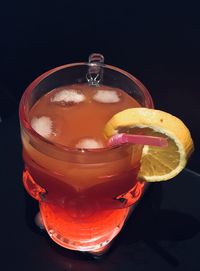 Close-up of drink on table against black background