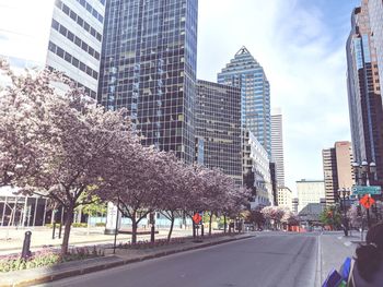 Panoramic view of city street and buildings against sky