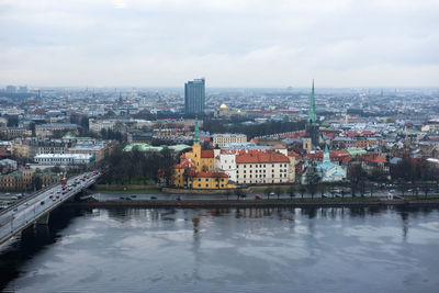 View of cityscape against cloudy sky