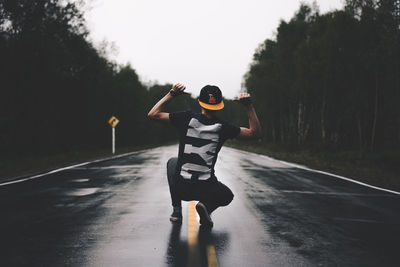 Rear view of man standing on road