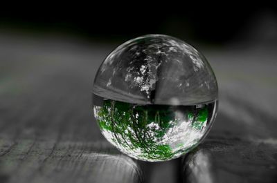 Close-up of crystal ball on glass of water