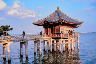View of pier on sea against cloudy sky