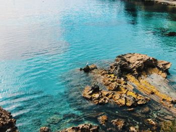 High angle view of rocks by sea