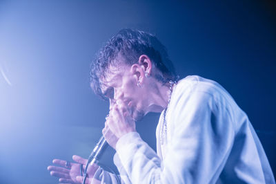 Young man playing at music concert