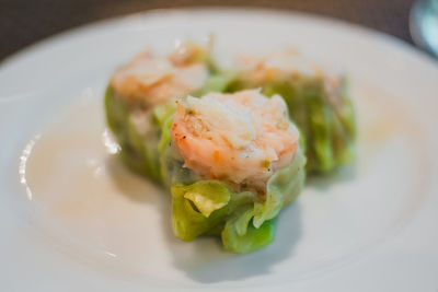 Close-up of fresh dim sum served in plate at restaurant