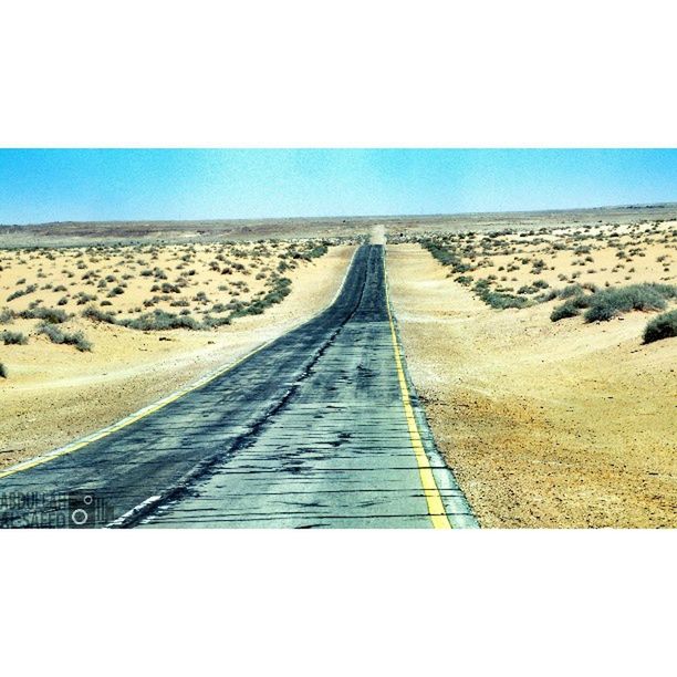 the way forward, diminishing perspective, vanishing point, landscape, sand, tranquil scene, horizon over land, transfer print, tranquility, clear sky, desert, auto post production filter, road, surface level, blue, transportation, sky, nature, long, scenics