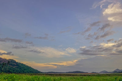 Scenic view of landscape against cloudy sky