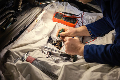 Midsection of man holding suitcase