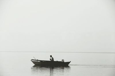 Man rowing boat in sea