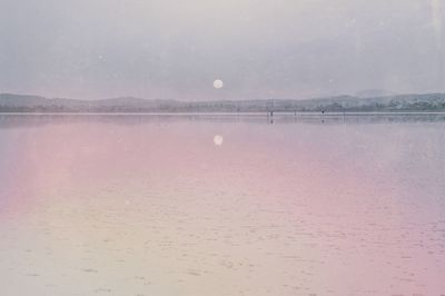 Scenic view of calm lake against sky