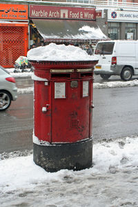 Red car on snow covered street