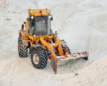 Bulldozer on snow covered field 