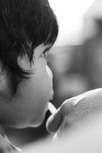 Close-up of boy looking away outdoors
