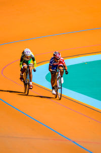 Bicycle parked against yellow wall