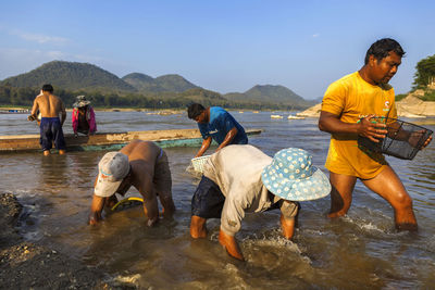 People on beach against sky