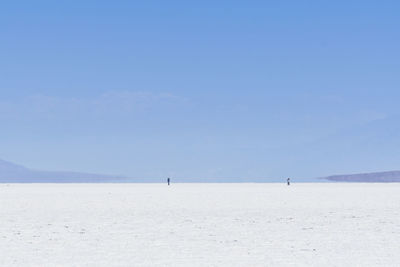 Scenic view of beach against blue sky