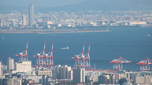 Aerial view of buildings in city against sky