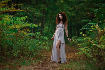 Woman standing in a forest