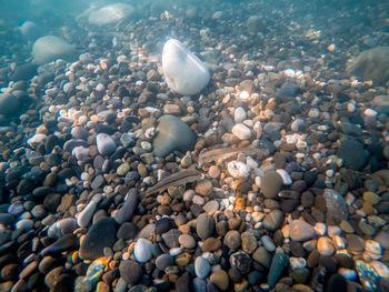 High angle view of pebbles on beach