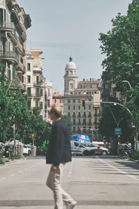 Rear view of woman walking on street in city