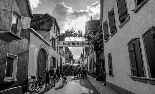 People on street amidst buildings in city