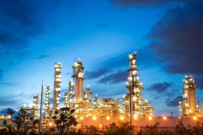 Chemical oil refinery plant, power plant and metal pipe on sunrise sky background.