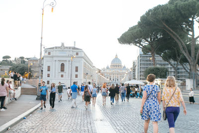 Group of people walking in front of building