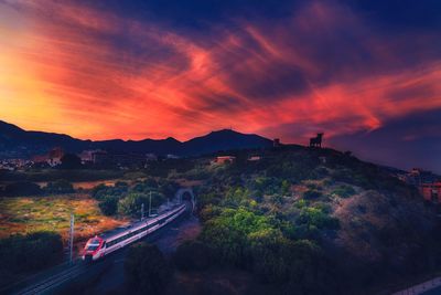 High angle view of silhouette mountains against sky during sunset