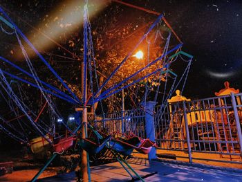 Illuminated ferris wheel at night