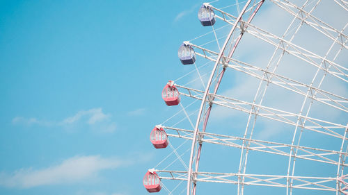 Low angle view of ferris wheel against sky